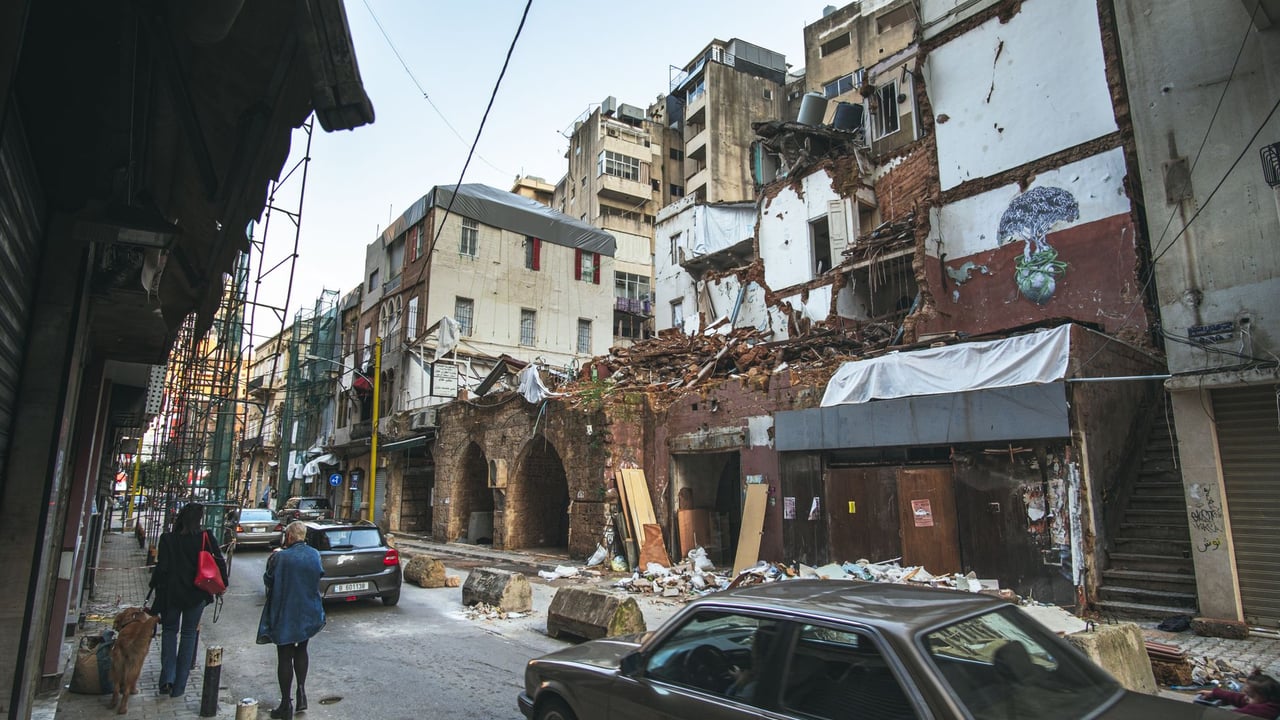 Street scene in Beirut depicting building damage and recovery efforts after the port explosion.