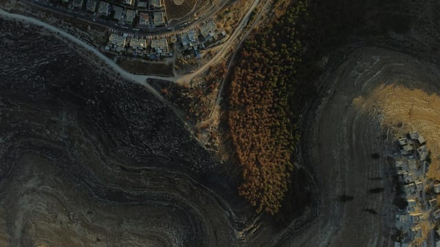 Stunning aerial view capturing residential and rugged natural landscape in Tekoa.