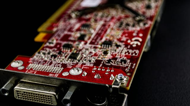 Detailed close-up of a red circuit board showcasing electronic components.