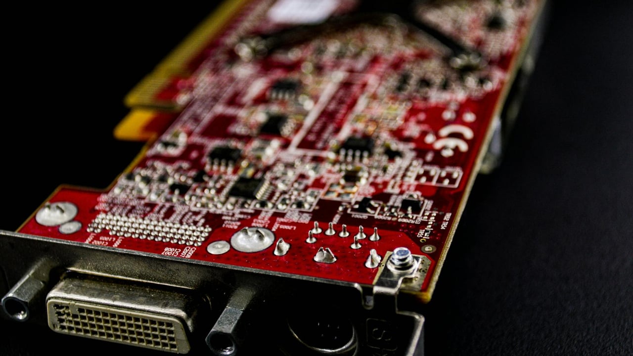 Detailed close-up of a red circuit board showcasing electronic components.