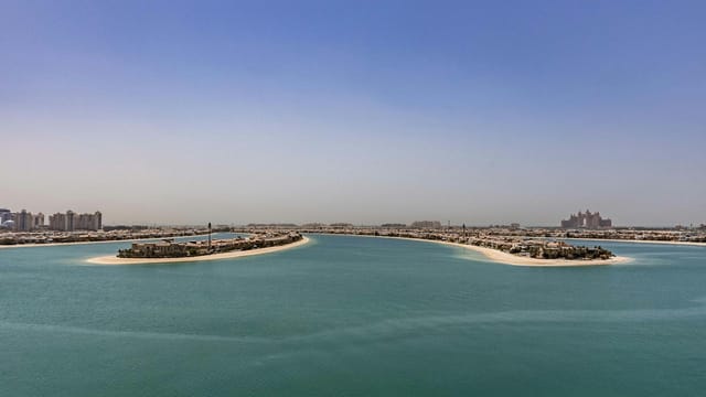 Stunning aerial view of Palm Jumeirah in Dubai under a clear blue sky.