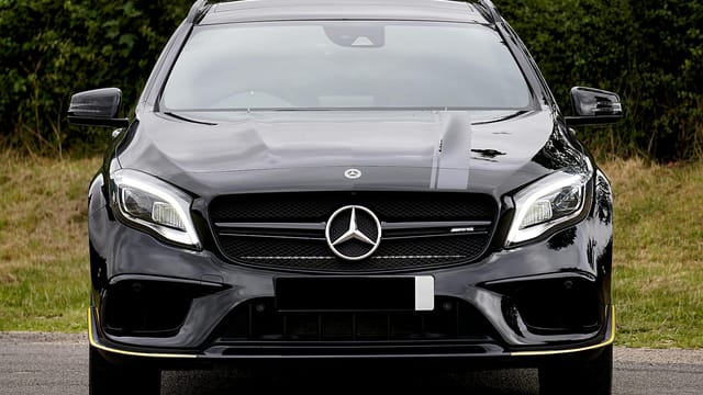 Luxurious black Mercedes-Benz AMG parked outdoors, showcasing elegance and style.