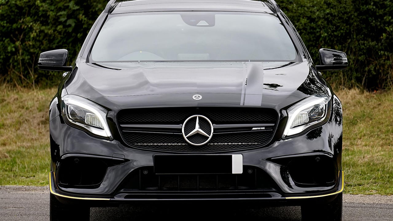 Luxurious black Mercedes-Benz AMG parked outdoors, showcasing elegance and style.