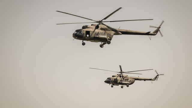 Two military helicopters flying in the sky above Belgrade, Serbia.