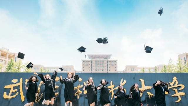 Graduates celebrate their success by tossing caps at Wuhan University, China.