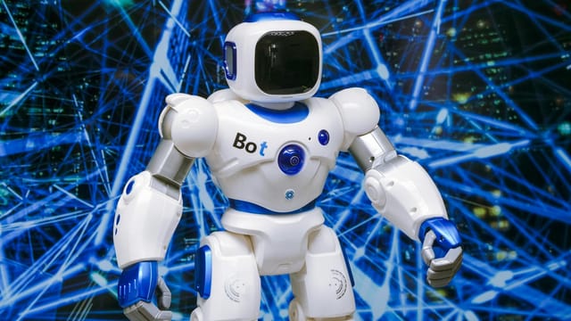 Advanced humanoid robot with glowing blue accents in a digital network setting.
