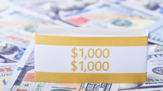 Focused view of US dollars wrapped in a currency band, perfect for finance and banking themes.
