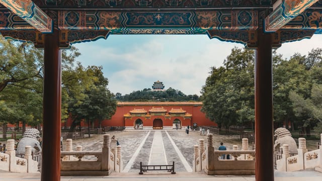 A beautiful view of traditional Chinese architecture in a scenic park setting, with vibrant colors and intricate designs.