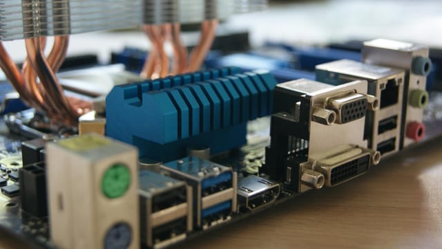 Detailed view of computer motherboard with various ports and connectors.