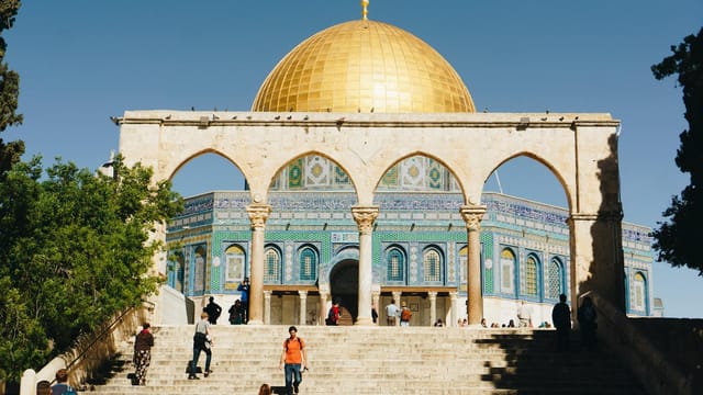 Stunning view of the Dome of the Rock in Jerusalem under clear blue skies.