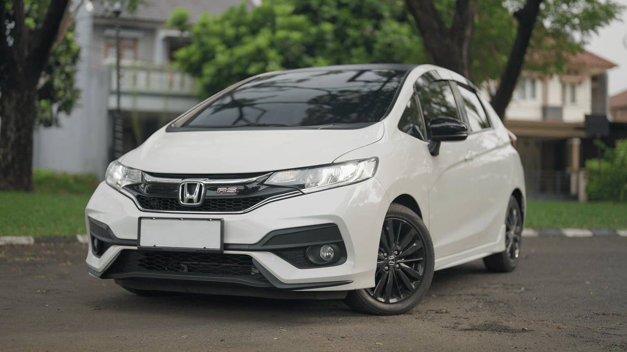 A stylish white Honda RS car parked in a serene residential neighborhood.