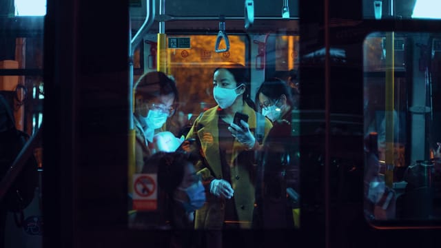 A scene of commuters wearing face masks on a Shanghai bus during the COVID-19 pandemic.