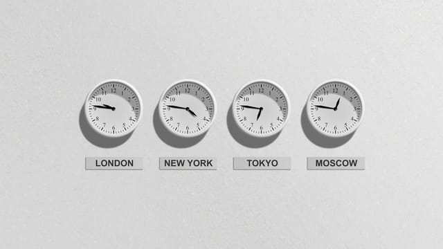 Four wall clocks showing different time zones for London, New York, Tokyo, and Moscow.