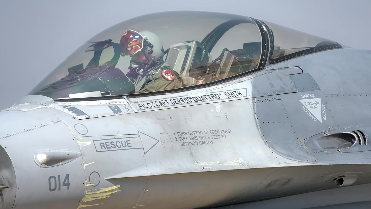 Close-up of a jet fighter cockpit with a pilot at the Bengaluru Air Show, showcasing the aircraft details and pilot gear.
