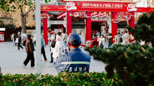 Vibrant street scene in Nanjing, China captures daily life and cultural elements during autumn.