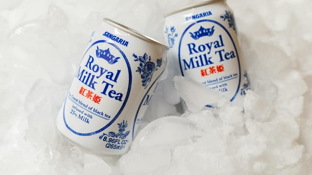Cold Royal Milk Tea cans nestled in ice, perfect for a refreshing beverage moment.