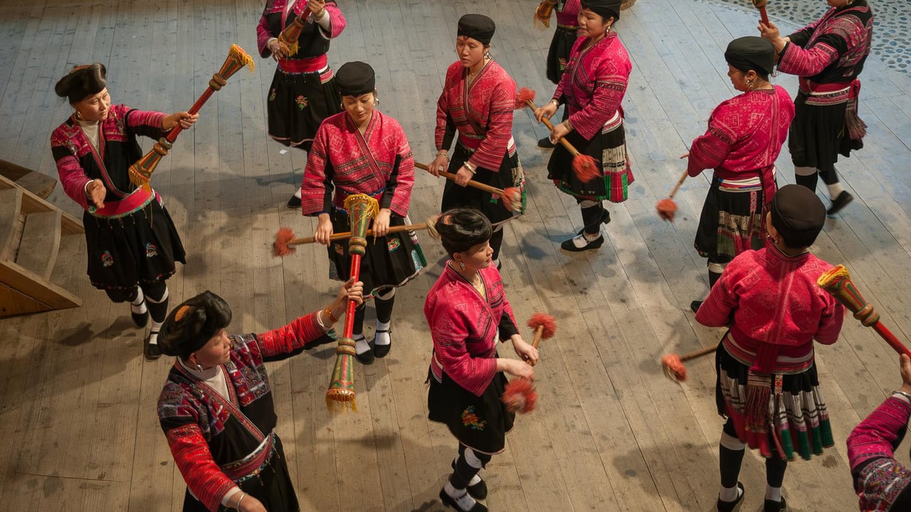 Colorful Yi dancers perform traditional dance in Guilin, Guangxi, showcasing vibrant costumes and cultural heritage.