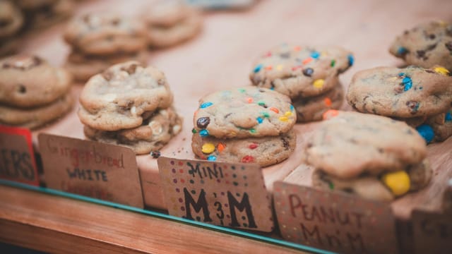 A mouth-watering close-up of assorted cookies displayed with colorful labels.
