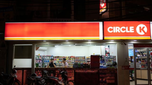 Brightly lit Circle K store with parked motorcycles and visible interior products.
