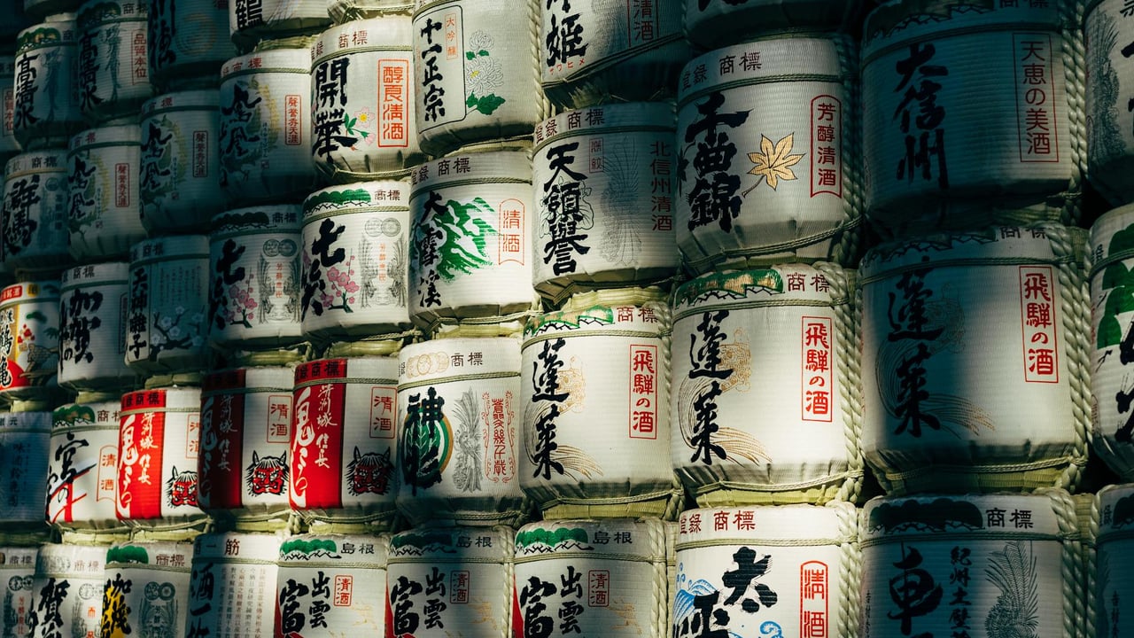 A wall of traditional sake barrels in Shibuya City, Tokyo, showcasing Japanese culture.