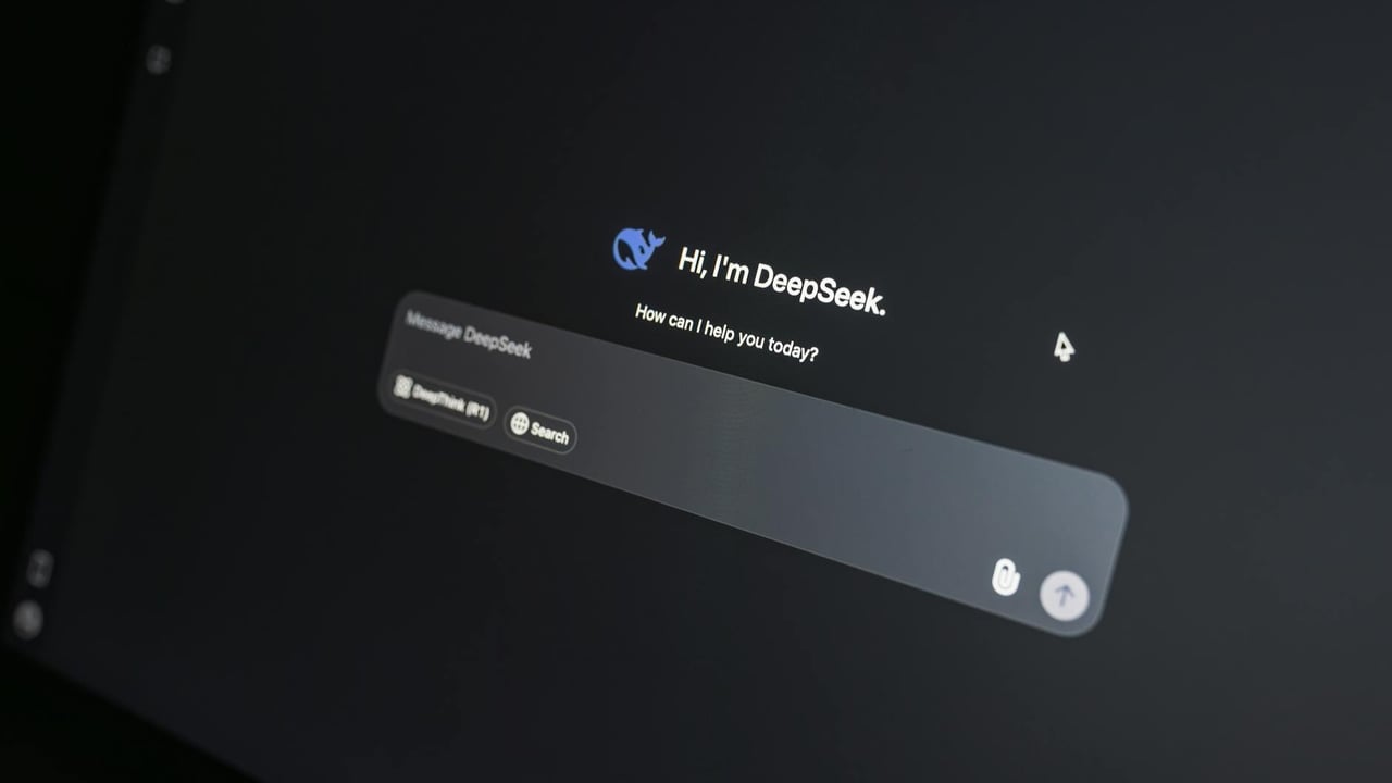 Close-up of DeepSeek AI chat interface on a laptop screen in low light.
