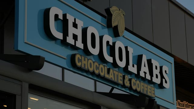Storefront signage for Chocolabs, highlighting chocolate and coffee offerings.