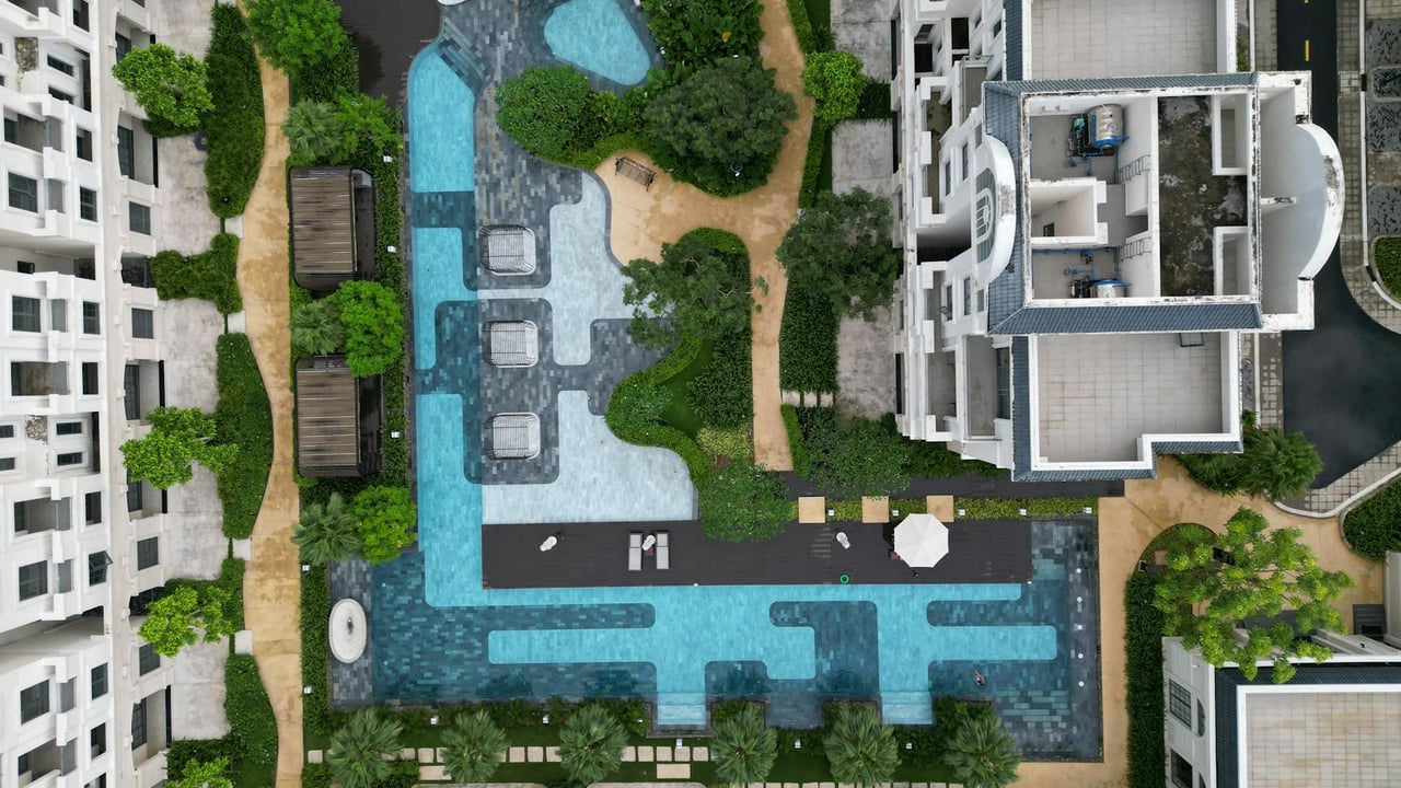 Stunning aerial shot of a resort pool surrounded by lush greenery in Đồng Nai, Vietnam.