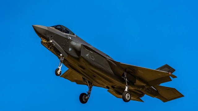 Close-up of an F-35 fighter jet capturing the essence of aviation prowess against a clear blue sky.