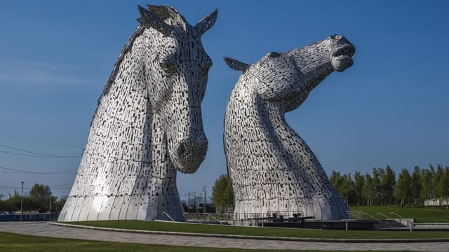 The Kelpies, iconic horse head sculptures in Falkirk, Scotland, on a sunny day.
