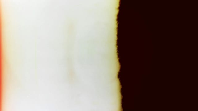 A vintage abstract light leak effect resembling classic retro film imperfections.