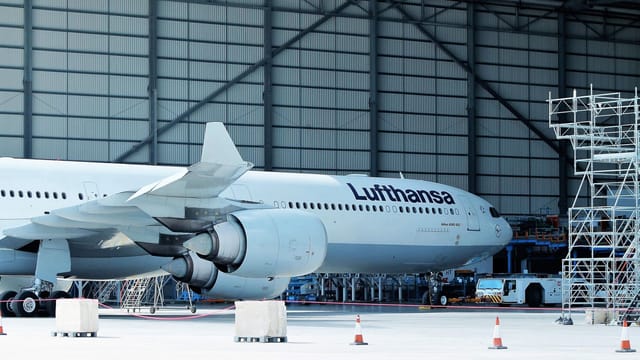 Lufthansa airplane under maintenance in hangar at Malta Airport.