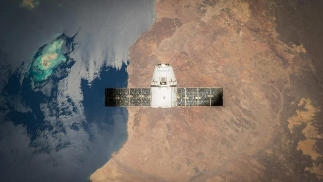 Satellite in orbit with detailed view of Earth and ocean below.