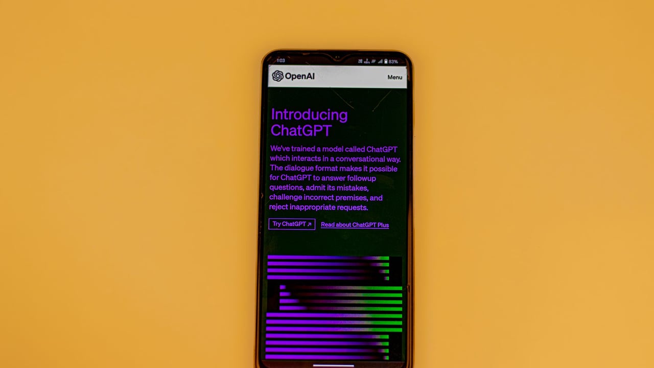 Smartphone displaying ChatGPT interface on a vibrant background, showcasing AI technology.