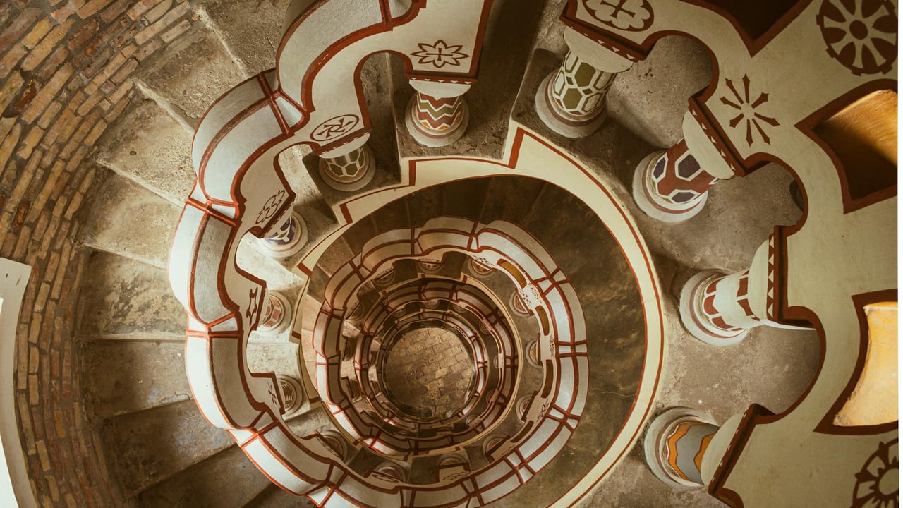 Intricate spiral staircase inside ornate Bory Castle, Hungary, showcasing unique architectural design.