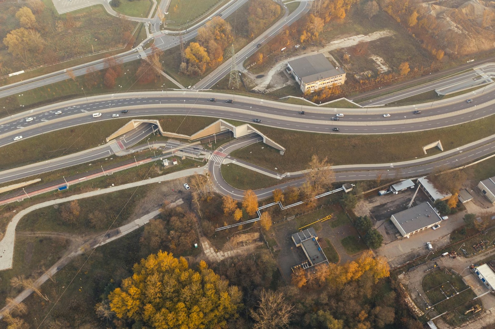 Aerial view of a highway intersection in Poznań, Poland, showcasing fall colors.