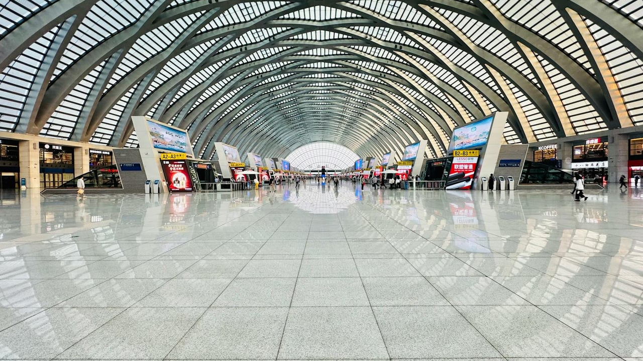 Panoramic view of a spacious and modern high-speed railway station interior with architectural elegance.