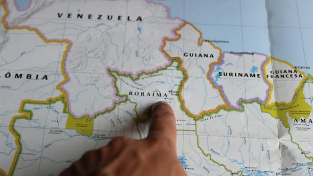 Discover Roraima, Brazil with a finger pointing on a detailed map.