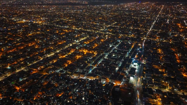 Aerial night shot of Karachi, Pakistan, showcasing the vibrant city lights and urban sprawl.