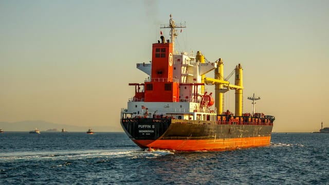 A vibrant container ship navigating the Bosphorus Strait, Istanbul during sunset, enhancing the maritime scenery.