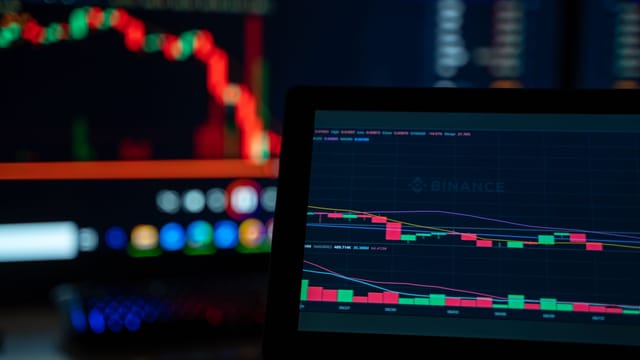 Bright trading screens depict cryptocurrency market trends in a tech setup.