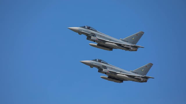 German Air Force Eurofighter Typhoons soaring in clear Slovakian sky.