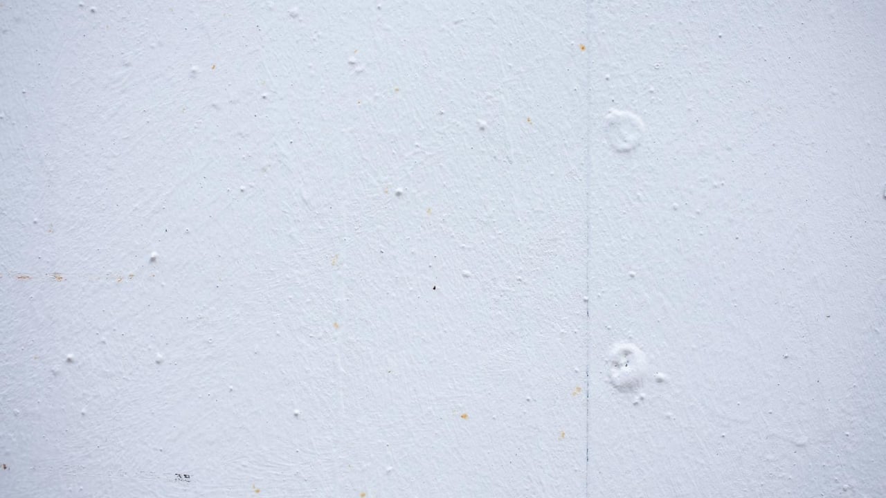 Textured backdrop of wall with spots and dots on shabby light blue surface
