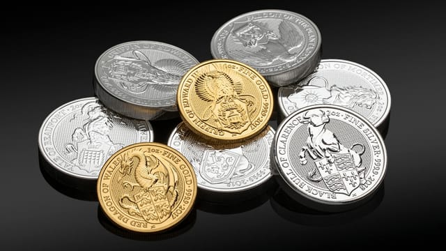 Close-up of valuable gold and silver coins showcasing intricate designs.