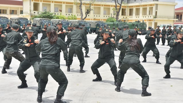 Soldiers participating in a coordinated outdoor training drill, displaying discipline and teamwork.