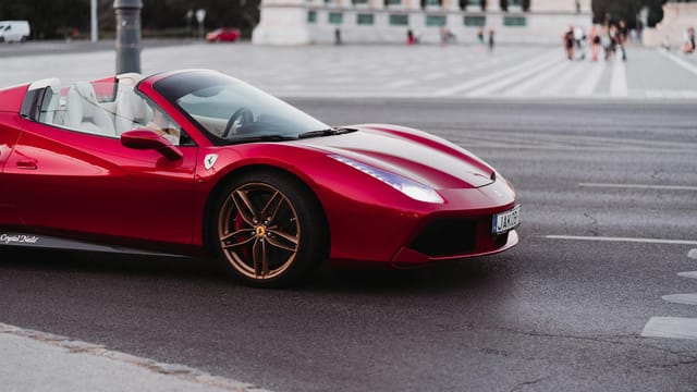 A stunning red Ferrari supercar captured on a city street, showcasing sophistication and speed.