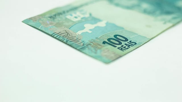 Macro shot of a Brazilian 100 Reais banknote isolated on a white background, featuring copy space.