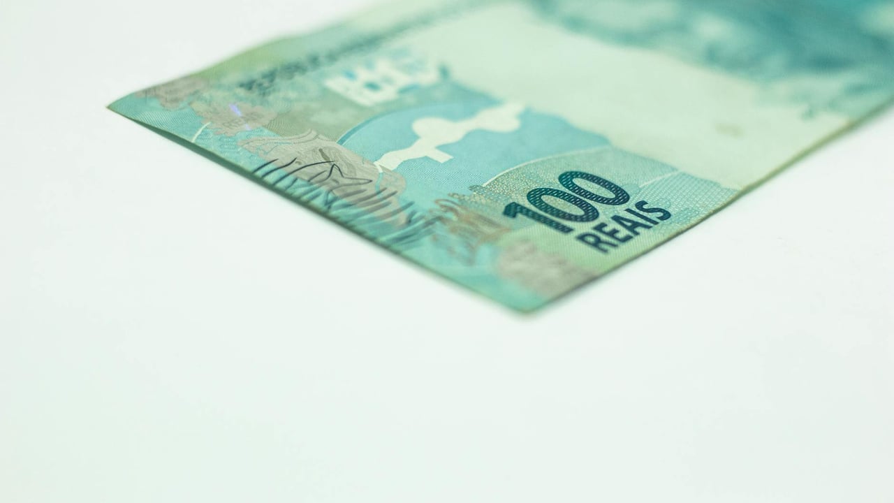 Macro shot of a Brazilian 100 Reais banknote isolated on a white background, featuring copy space.