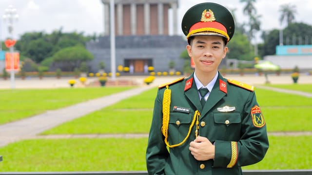 Vietnamese soldier in uniform posing at Ho Chi Minh Mausoleum in Hanoi, Vietnam.
