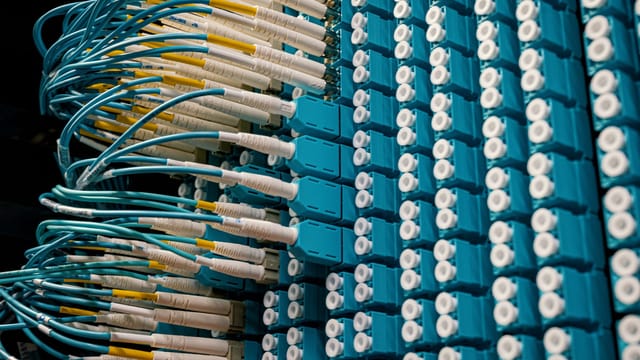 From below of fiber optic equipment with similar colorful rubber cables and round sockets