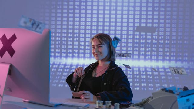 Smiling woman surrounded by digital and physical currency in a tech office setting.
